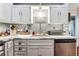 Bright farmhouse-style kitchen with marble counters, stainless steel appliances, and white cabinets at 4828 Lakewood Dr, Acworth, GA 30101