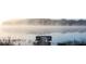 Picturesque lake view with a dock extending into the tranquil water, shrouded in mist at 4828 Lakewood Dr, Acworth, GA 30101