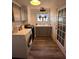 Well-lit laundry room features grey cabinetry, updated washer/dryer, wood-look floor and window at 4828 Lakewood Dr, Acworth, GA 30101