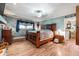 Spacious main bedroom boasts a large bed, hardwood floors, and a stylish light fixture at 4828 Lakewood Dr, Acworth, GA 30101