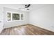 Bright bedroom featuring a ceiling fan, bay window, and hardwood floors at 5915 Trent Walk Dr, Lithonia, GA 30038