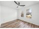 Bedroom with large windows, hardwood-style flooring, and a modern ceiling fan at 5915 Trent Walk Dr, Lithonia, GA 30038