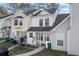 Exterior view of townhomes, each featuring a covered porch and manicured front yard at 5915 Trent Walk Dr, Lithonia, GA 30038