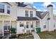 View of townhome with a concrete walkway, covered porch, and a chimney at 5915 Trent Walk Dr, Lithonia, GA 30038