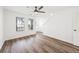 Bright living room with wood-look floors, staircase, and natural light at 5915 Trent Walk Dr, Lithonia, GA 30038