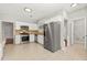 Modern kitchen with stainless steel appliances, white cabinets, and tile flooring at 2829 Priestcliff Se Dr, Smyrna, GA 30080