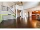 Expansive living room with wood floors, staircase, and open floor plan into the kitchen at 2935 Wardlaw Ln, Buford, GA 30519