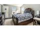 Cozy bedroom with a decorative headboard, neutral walls, and two windows at 5987 Westchase St, Atlanta, GA 30336