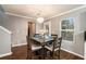 Bright dining area with hardwood floors, a modern chandelier, and backyard access at 5987 Westchase St, Atlanta, GA 30336