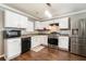 Modern kitchen featuring white cabinetry, stainless steel appliances, and wood-look floors at 5987 Westchase St, Atlanta, GA 30336
