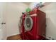 Laundry room with red washer and dryer at 5987 Westchase St, Atlanta, GA 30336