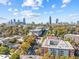 An aerial view of the property showing the cityscape skyline and lush green surroundings at 650 Glen Iris Ne Dr # 15, Atlanta, GA 30308