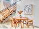 Cozy dining area with a round wood table and a modern wooden staircase nearby at 650 Glen Iris Ne Dr # 15, Atlanta, GA 30308