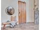 Modern entryway with hardwood floors, circular mirror, and bench seating at 650 Glen Iris Ne Dr # 15, Atlanta, GA 30308