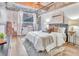 Inviting bedroom with exposed brick accent, hardwood floors, and a plush bed at 650 Glen Iris Ne Dr # 15, Atlanta, GA 30308