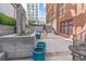 Concrete patio showcasing a modern water feature, blue planters, and black outdoor furniture at 650 Glen Iris Ne Dr # 15, Atlanta, GA 30308