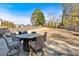 Relaxing backyard patio with stone flooring, wicker furniture and large fenced in backyard at 10780 S Kimball Bridge Xing, Alpharetta, GA 30022