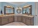 Charming bathroom with dual vanities, granite countertops, framed mirrors and soft blue walls at 10780 S Kimball Bridge Xing, Alpharetta, GA 30022