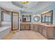 Light-filled bathroom with walk-in shower, soaking tub and granite counters at 10780 S Kimball Bridge Xing, Alpharetta, GA 30022