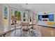 Bright dining area with backyard views adjacent to the living room at 10780 S Kimball Bridge Xing, Alpharetta, GA 30022
