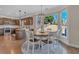 Bright dining area with views of the backyard and access to the kitchen at 10780 S Kimball Bridge Xing, Alpharetta, GA 30022