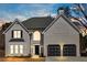 Charming two-story home with a light-colored brick exterior, black shutters, and a well-manicured lawn at 10780 S Kimball Bridge Xing, Alpharetta, GA 30022
