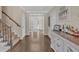 Beautiful foyer with hardwood floors, a staircase, and a decorative table with a mirror above it at 10780 S Kimball Bridge Xing, Alpharetta, GA 30022