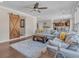 Comfortable living room with hardwood floors, a ceiling fan, and a view of the dining area at 10780 S Kimball Bridge Xing, Alpharetta, GA 30022