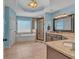 Bright main bathroom with blue walls, a soaking tub, walk-in shower, and dual vanities at 10780 S Kimball Bridge Xing, Alpharetta, GA 30022