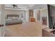 Spacious main bedroom featuring plenty of natural light, fireplace, and plush carpet at 10780 S Kimball Bridge Xing, Alpharetta, GA 30022