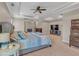 Spacious main bedroom with tray ceiling, fireplace, and a large bed with blue accents at 10780 S Kimball Bridge Xing, Alpharetta, GA 30022