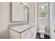 Bathroom with a sink vanity, toilet, large mirror, and natural light from a window at 112 Dallas Mark Drive, Canton, GA 30115