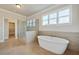 Elegant bathroom with a freestanding tub, glass shower, and neutral tile, offering a spa-like experience at 112 Dallas Mark Drive, Canton, GA 30115