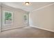 Neutral bedroom with two windows, carpet flooring and crown molding, perfect for relaxation at 112 Dallas Mark Drive, Canton, GA 30115