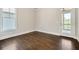Empty bedroom features hardwood floors, white trim, and a glass door leading to the outside at 112 Dallas Mark Drive, Canton, GA 30115