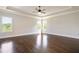 Spacious empty bedroom features hardwood floors, white crown molding, and many windows with natural light at 112 Dallas Mark Drive, Canton, GA 30115
