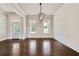 Bright dining area with hardwood floors, wainscoting and a modern light fixture at 112 Dallas Mark Drive, Canton, GA 30115