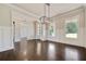 Elegant dining room featuring hardwood floors, wainscoting, and abundant natural light at 112 Dallas Mark Drive, Canton, GA 30115