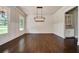 Spacious dining room with wainscoting, hardwood floors, and modern chandelier at 112 Dallas Mark Drive, Canton, GA 30115