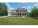 Elegant two-story home featuring a welcoming front porch and a well-manicured lawn at 112 Dallas Mark Drive, Canton, GA 30115