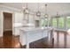 Open kitchen featuring a large island, white cabinetry, and stainless steel appliances at 112 Dallas Mark Drive, Canton, GA 30115