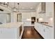 Modern kitchen with an island featuring white cabinets, stainless appliances, and a marble countertop at 112 Dallas Mark Drive, Canton, GA 30115
