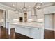 Elegant kitchen showcasing white cabinetry, stainless steel appliances, and a spacious island with marble countertop at 112 Dallas Mark Drive, Canton, GA 30115