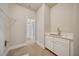 Functional laundry room with a utility sink, storage cabinets, and tile floors at 112 Dallas Mark Drive, Canton, GA 30115