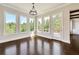 Bright sunroom featuring large windows with natural light, hardwood floors, and views of the outdoors at 112 Dallas Mark Drive, Canton, GA 30115