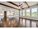 Open floor plan with hardwood floors, wood beams, many windows, and a view of the modern kitchen at 112 Dallas Mark Drive, Canton, GA 30115