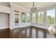 Sunroom featuring large windows with natural light, hardwood floors, and views of the outdoor scenery at 112 Dallas Mark Drive, Canton, GA 30115