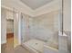 Modern glass shower with neutral tile and bench seating, leading to a walk-in closet at 112 Dallas Mark Drive, Canton, GA 30115