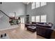 Living room features hardwood floors, a staircase with iron spindles, and an oversized sectional sofa at 142 Parkway Dr, Fairburn, GA 30213