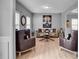 Comfortable living room featuring hardwood floors, a decorative fireplace, and large windows at 142 Parkway Dr, Fairburn, GA 30213